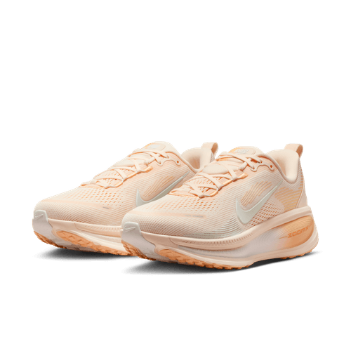 Et par Nike Vomero 18 løbesko dame i Guava Ice/Sail-Orange Chalk med hvide mellemsåler, diskrete orange detaljer, ZoomX-støddæmpning og hvide Nike swoosh-logoer, vist på en almindelig hvid baggrund.