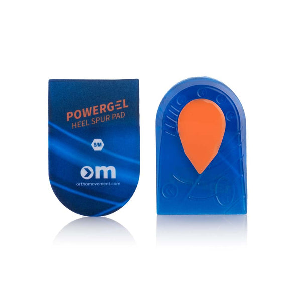 Der vises to blå Ortho Movement Heel Spur Pads (Unisex); på den ene står der "POWERGEL HEEL SPUR PAD S/M orthomovement.com", mens der på den anden er en orange gelzone, som giver ekstra stødabsorbering i dine indlægssåler.