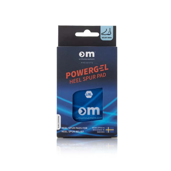 En blå og sort Ortho Movement Heel Spur Pad, Unisex, Blå æske mærket med stødabsorbering for hælspore, komfort som skoindlæg, info om størrelse L/XL og en ophængningsfane i toppen.