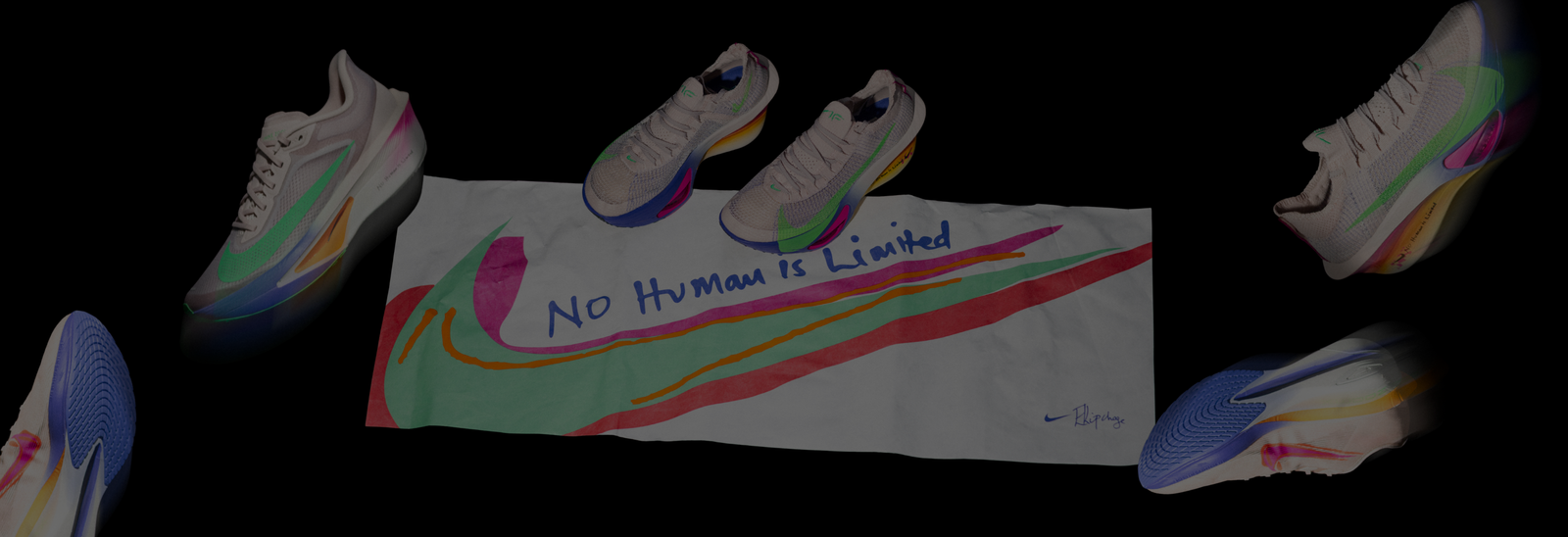 Seks flerfarvede Nike-løbesko og et hvidt banner med en stor swoosh og teksten No Human is Limited vises mod en sort baggrund.