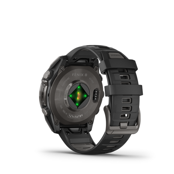 På bagsiden af Garmin Fenix 8 Amoled Sapphire Titanium 47 mm kan man se den koksgrå/pebblegrå silikonerem, den runde bagkasse og de grønne sensorer, der lyser op under dette premium smartwatch.