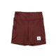 Et par røde Saysky W Combat+ Short Tights 7" til kvinder med sidelommer og et hvidt Saysky-mærke med en stjerne nederst på venstre ben, som ligger fladt på en hvid baggrund. Ideelle til korte dame- eller træningstights.