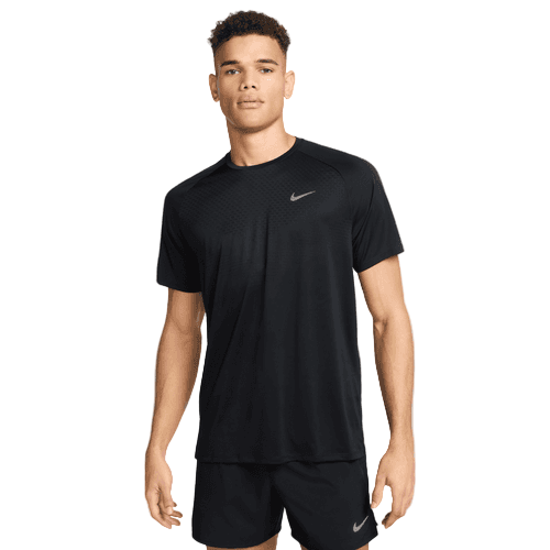 En ung mand står med ansigtet fremad i en Nike Stride SS Running Top, Herre, Black/Reflective Silv, og matchende sorte shorts. Begge har det hvide Nike-logo. Baggrunden er helt hvid.