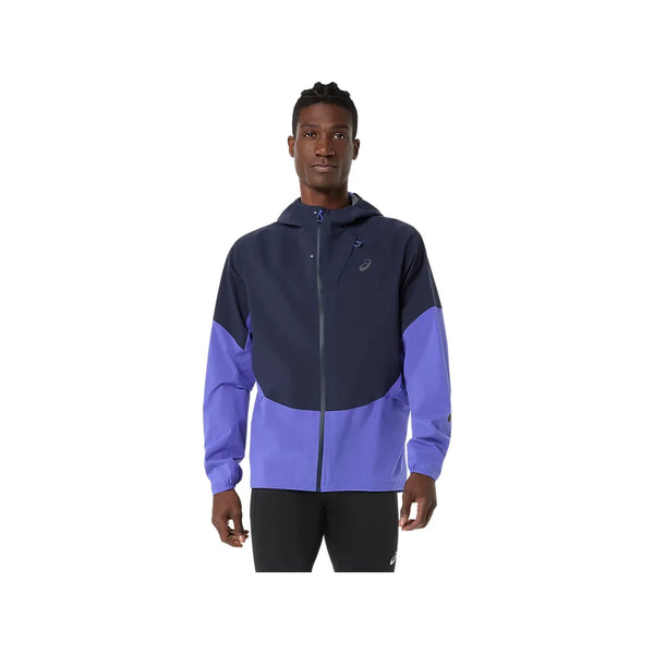 En mand kigger fremad iført ASICS Metarun Legend Jacket til mænd i Midnight/Cobalt Burst/Illuminate Green med sorte bukser og står på en almindelig hvid baggrund.