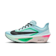 Nike Zoom Fly 6 Herre i Glacier Ice/Black-Hyper Pink-Green Shock har en overdel i mesh, Cushlon-skumdæmpning, ZOOMX-tekst på den hvide mellemsål, fed sort swoosh og et slankt aerodynamisk design med grønne og pink accenter.