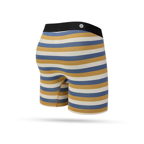 Stance Highland Wholester boxershorts til mænd i khaki har en sort linning og vandrette sennepsgule, blå, hvide og grå striber på en hvid baggrund.