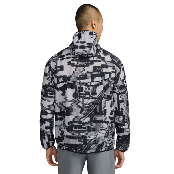 En person set bagfra har en grå og sort Nike Repel UV Protection Running Jacket, Herre, Stealth på – en let, vandafvisende løbejakke med abstrakt camouflagemønster.