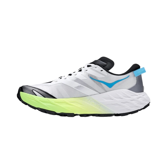 En hvid Hoka Speedgoat 7-damesko i farvekombinationen Frost / Neon Yuzu med sorte, limegrønne og grå detaljer, et blåt logo og en tyk, struktureret sål, der er ideel til trailløb, vises i profil vendt mod venstre på en ensfarvet hvid baggrund.