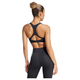 En kvinde med krøllet hår i en knold ses bagfra iført Adidas Adizero Medium Support Run Bra, Dame, Black, sammen med højtaljede sorte leggings og klar til løb mod en hvid baggrund.