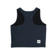 W Combat Rib Crop Top fra Saysky er en ærmeløs blå top til kvinder, vist fladt med ryggen opad. Den har brede skulderstropper, sort foring og et lille hvidt rektangulært mærke med en sort stjerne nær kanten.