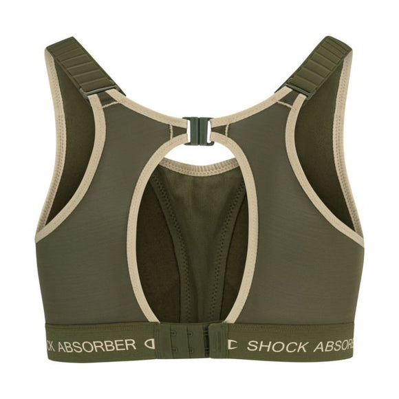 Bagsiden af Shock Absorber Ultimate Run Bra Padded, Dame, Green med beige kant, justerbare stropper, nøglehulsudskæring, spænde på ryggen for maksimal støtte og elastikbånd med mærke.