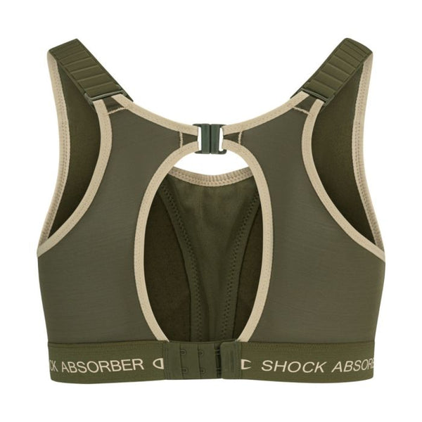 Bagsiden af Shock Absorber Ultimate Run Bra Padded, Dame, Green med beige kant, justerbare stropper, nøglehulsudskæring, spænde på ryggen for maksimal støtte og elastikbånd med mærke.