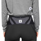 En person i grå langærmet skjorte og sorte sportsbukser ses bagfra iført et Saysky Flow Belt, Unisex, Black. Bæltet har et rektangulært mærke med en sort stjerne - ideelt til at bære løb-essentials sikkert.