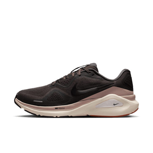 Nike Structure 26 herre i Medium Ash/Black-College Grey har en overdel i mesh, sort Swoosh-logo og en hvid-beige støddæmpende sål for stabilitet, vist i sideprofil på en almindelig hvid baggrund.