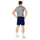 En mand ser væk fra kameraet iført en grå t-shirt, blå Saysky Pace 2in1 Shorts 5" (Herre), hvide sokker og hvide sneakers på en almindelig hvid baggrund.