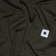 Saysky W Pace 1/2 Zip Long Sleeve til kvinder i grøn har en hvid firkantet patch med en sort stjerne og viser synlige folder og en blød tekstur.