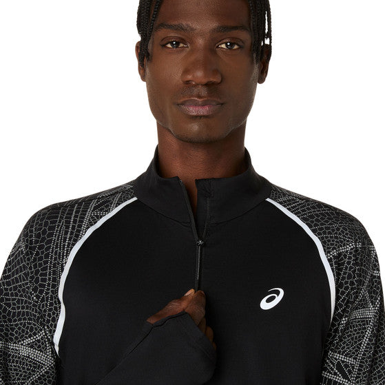 En person iført Limited Series Lite-Show Ls Top fra Asics i Performance Black med hvide refleksdetaljer og ASICS-logo holder lynlåsen i midten. Baggrunden er ensfarvet hvid.