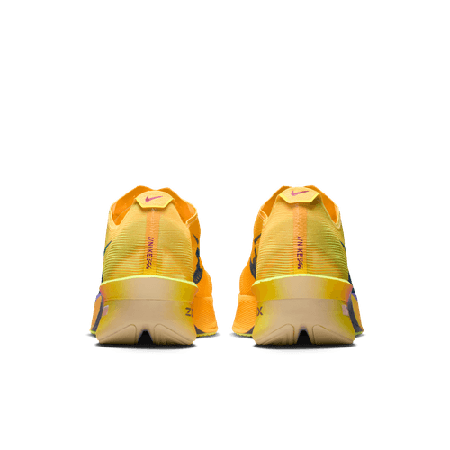 Et par Nike Vaporfly Next% 4 løbesko i Citron Pulse/Indigo Burst-Laser Orange vises bagfra på en hvid baggrund med en beige sål, orange og lilla detaljer, ZoomX-skumdæmpning og logoet på hælkappen.