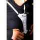 En person i en sort jakke justerer en BeeSafe LED Harness USB Phone Pocket, Unisex, Silver med teksten "WE RUN COPENHAGEN". Fire hvide frontlys er tændt, hvilket gør den ideel til løbeture i mørket.