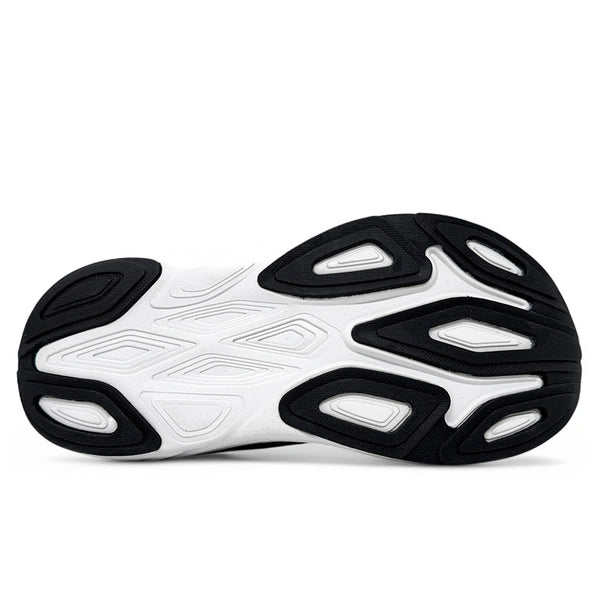 Billedet viser undersiden af New Balance Freshfoam More V6, Herre, Mineral. Den hvide sål har sort gummigreb og geometriske former for optimal komfort og greb i løbesko til mænd.