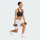 Iført Adidas Adi365 Pkt Bra, Dame, Black, og hvide shorts laver en person et udfald med en håndvægt i hver hånd.