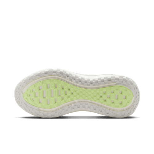 Billedet viser ydersålen på Nike Vomero Plus, Dame, Sail/Metallic Silver-Barely Volt. Den overvejende hvide sål har et gennemskinneligt lysegrønt gittermønster i midten, som giver et godt greb, med afrundede, strukturerede kanter.