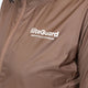 Nærbillede af Liiteguard Aero-Tech Windbreaker, Dame, i Cocoa Brown. Har et hvidt broderet "liiteGuard INNOVATIVE SPORTSWEAR"-logo på venstre bryst. Fremstillet af let, skinnende, åndbart, vand- og vindafvisende materiale.