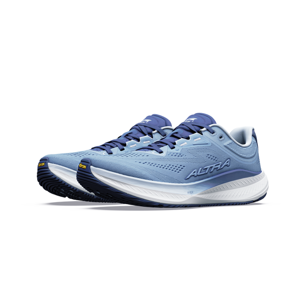 Et par Altra Torin 9 Dame i farvekombinationen Windward Blue/White/Dark Denim med hvide mellemsåler, mørkeblå ydersåler og ALTRA-logo på siden, udført i Zero Drop-design, vises på en ensfarvet hvid baggrund.