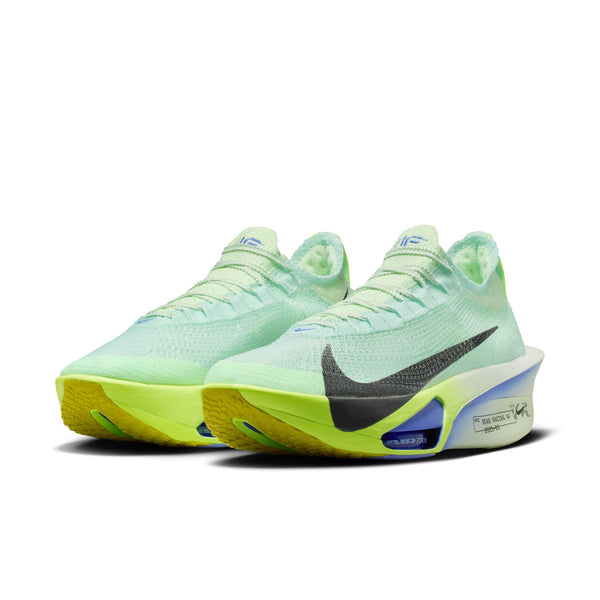 Nike Alphafly Next% 3 Herre i Barely Green/Black Spruce-Volt Tint har en overdel i lysegrønt mesh, stor sort Swoosh, synlige blå støddæmpningsenheder og en gulgrøn ydersål med gradient på en hvid ZoomX-mellemsål i skum.