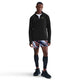 En mand ser frem for sig iført en sort Nike Nk Df Jakob Hz-pullover (Herre), hvid undertrøje, farverige sportsshorts, lange sorte kompressionsstrømper og sorte sportssko på en hvid baggrund.