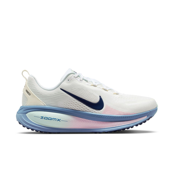 Nike Vomero 18-løbesko til kvinder i farvekombinationen White/Midnight Navy-Work Blue byder på maksimal støddæmpning, en hvid overdel, en blå sål, en lyserød mellemsål med farveovergang, et mørkeblåt Swoosh-logo, hvide snørebånd og ZOOMX-detaljer, der giver ekstra stil.