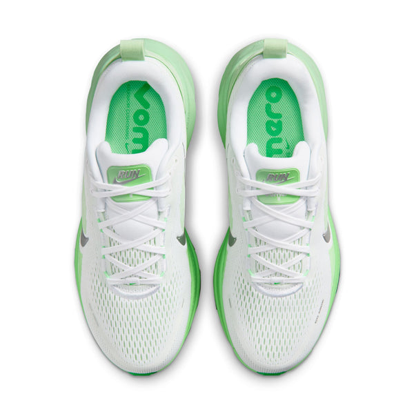 Et par Nike Vomero 18 løbesko til kvinder i farvekombinationen White/Metallic Silver-Illusion Green, set ovenfra. Overdelen i mesh er hvid med grønne detaljer, og skoene har hvide snørebånd samt en grøntfarvet sål, der sikrer maksimal dæmpning og komfort. Indlægssålerne er grønne med hvid tekst, hvilket fremhæver det elegante design fra Nike.