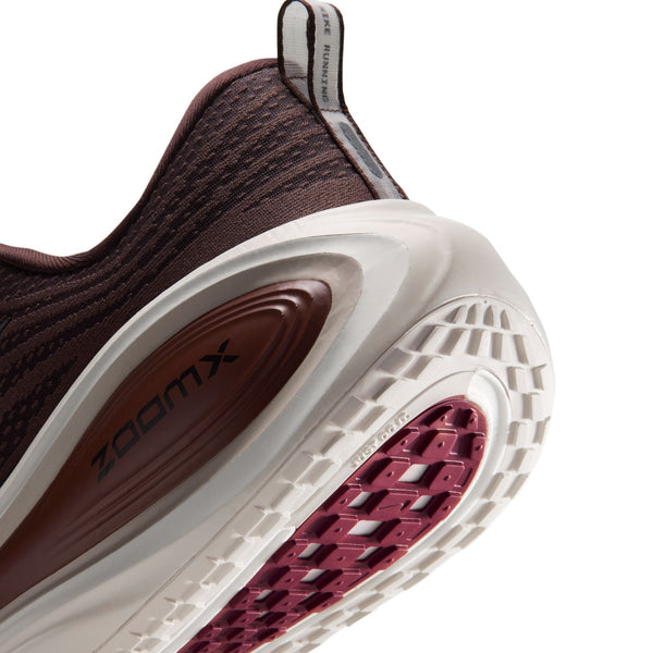 Nærbillede af hælen på et par Nike Vomero Plus i farven Baroque Brown/Black-Phantom, der viser den strukturerede mellemsål, ZoomX-logoet og det mønstrede ydersålmønster.