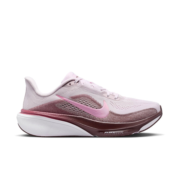 Nike Pegasus 42 til kvinder, der her præsenteres på en hvid baggrund, har en overdel i mesh i farverne »Bleached Lilac« og »Pink Rise« med detaljer i »Mystic Dates«. Skoen udmærker sig ved sin mellemsål med farveovergang, den synlige Air Zoom-støddæmpning og det ikoniske Nike-swoosh-logo på siden.