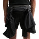 En person i Nike ACG "Second Sunrise" 5" Brief-Lined Shorts (Black/Anthracite/Summit White) med en sort jakke bundet i taljen, vist bagfra med kun underkroppen og overbenene synlige.