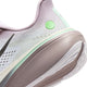Et nærbillede af hælen og sålen på Nike Pegasus 42 Dame-løbeskoen i farvekombinationen Lt Violet Ore/Baroque Brown-Sea Glass viser pastelfarver med en lysegrøn cirkulær detalje, en ydersål i struktureret gummi og en overdel i mesh med synlige sømme og perforeringer. ReactX-skummellemsål-mellemsålen giver responsiv støddæmpning, mens den innovative Air Zoom-teknologi sikrer en jævn og behagelig løbeoplevelse.