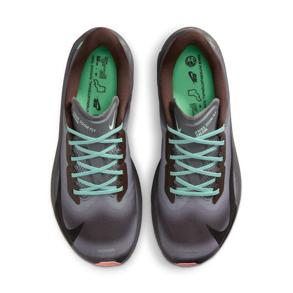 Oversigtsbillede af et par Nike Zoom Fly 6, Herre, Baroque Brown/Black-Smoke Grey-Ironstone løbesko med lyseblå snørebånd, brunt inderfor og grønne indlægssåler med trykte motiver og tekst. Disse løbesko er placeret side om side på en hvid baggrund.