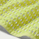 Nærbillede af den lysegule Stride Aero-FIT langærmet løbetrøje til mænd i farven Lt Lemon Twist/Black i mesh-stof med forstærket kant.
