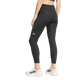 Der ses en person, der står på en ensfarvet lys baggrund med ryggen til kameraet. Personen har sorte Adi365 Seasonal 7/8-tights til kvinder fra Adidas på, en sort sports-BH og hvide Adidas-sneakers. Disse svedtransporterende tights sikrer både komfort og ydeevne til enhver træningssession.