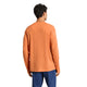 En person med kort, krøllet mørkt hår ses bagfra iført en orange Adidas Adi365 Longsleeve Shirt for men og blå bukser på en almindelig hvid baggrund.