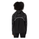 En kvinde med krøllet hår, set bagfra, er iført Asics Limited Series Lite-Show Jacket i Performance Black. Den har et hvidt geometrisk mønster, en reflekterende vandret stribe bagpå, lange ærmer og en afslappet pasform.