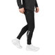 En person iført sorte Blaze+ Long Winter Tights, Herre, Black med et logo på underbenet og hvide sneakers.