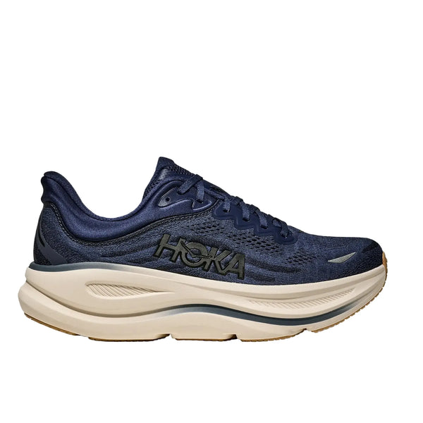 Hoka Bondi 9 herre i Midnight Blue/Varsity Navy har en tyk, hvid polstret sål for maksimal komfort, sort HOKA-branding på siden og er vist i sideprofil på en hvid baggrund.