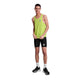En person står og smiler iført en Saysky Reactive Flow Singlet, Herre, Yellow Logo-en ultralet løbetøj herre-sorte tætsiddende shorts, hvide strømper og sorte sportssko på en almindelig hvid baggrund.