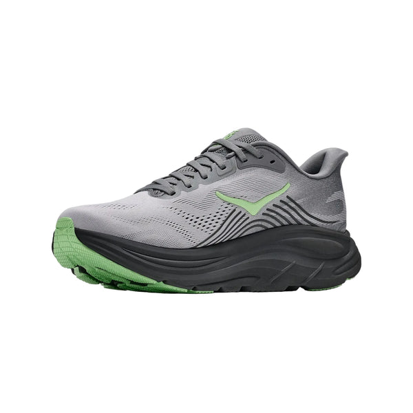En Hoka Clifton 11, herresko i farvekombinationen Galactic Grey / Stardust, med maksimal støddæmpning, en tyk sort og grøn sål samt et overmateriale, der ligner mesh, ses set fra siden på en hvid baggrund.