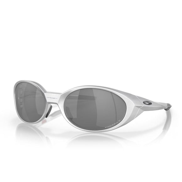 Oakley Eye Jacket Redux-solbrillerne i sølv med Prizm Black Polarized-glas har et tykt ovalt stel og Oakley-logo på tindingen, der vises på en hvid baggrund med en subtil refleksion.