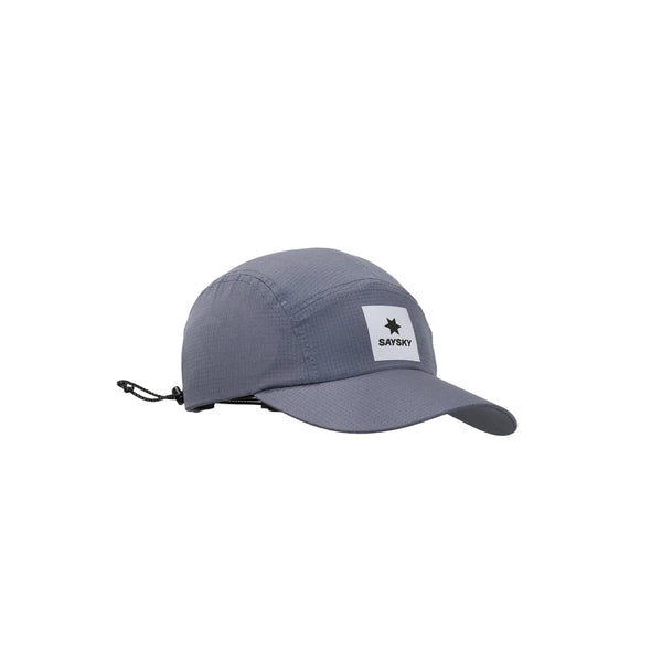 Her præsenterer vi Saysky Flow Cap, unisex, i grå – en løbekasket med fem paneler, en smal skygge og et hvidt, firkantet mærke foran, prydet med en stjerne og »SAYSKY«-logoet. Denne løbekasket er fremstillet af ultralette, åndbare materialer, der sikrer optimal komfort under dine løbeture, og har en justerbar snor bagpå, så pasformen kan tilpasses efter behov. Kasketten er fotograferet på en ren, hvid baggrund.