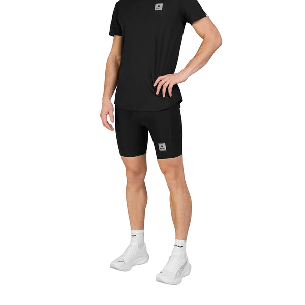 Mand iført en sort T-shirt og Saysky Flow+ Race Short Tights 7″, Herre, Sort med sidelomme, hvide sokker og hvide sneakers.