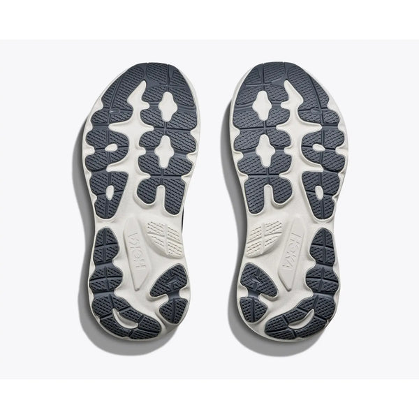 Et par Hoka Gaviota 6 såler til sportssko til mænd i Midnight Blue/Faded Navy med hvid bund og mørkeblå segmenterede slidbanemønstre vises side om side. Hokas branding ses på begge såler.