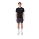 En person står og kigger fremad iført en sort t-shirt, Liiteguard Glu-Tech Running 2In1 Shorts for men in Ebony, hvide strømper og hvide sneakers på en almindelig hvid baggrund.